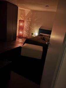 a dark room with a bed and a light at ROOM33 in Viagrande