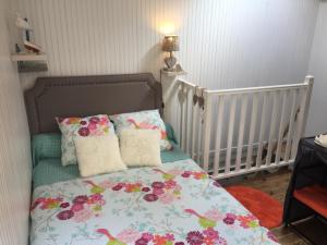 a bedroom with a bed with pillows and a crib at Cabanon de pêcheur in Marseille