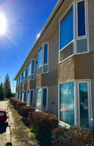 a building with many windows on the side of it at Bay Hill Inns & Suites in Neepawa