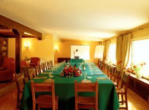 a long table with a green table cloth and flowers on it at Parador de Fuente Dé in Fuente Dé