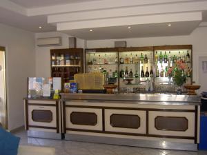 a bar with a counter with bottles of alcohol at Baia del Sole in Paestum
