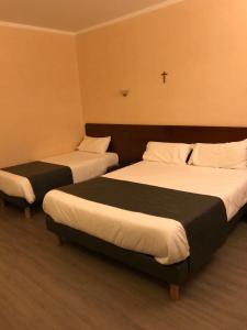Voodi või voodid majutusasutuse Hôtel Vesuvio toas
