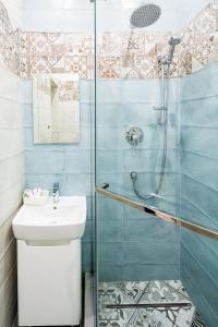 a bathroom with a shower and a sink at Old Town Cosy Apartment in Lviv