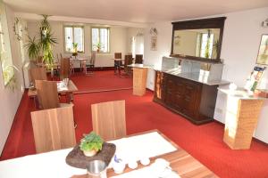 a room with a restaurant with tables and chairs at Haus Sankt Florian in Halberstadt