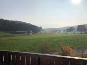 a large green field with a house in the distance at Ferienwohnung Aretsried 2 in Fischach