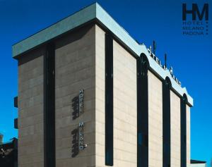 a building with the words hoteluminati on the side of it at Hotel Milano in Padova