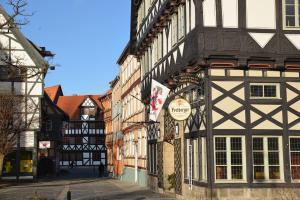 an old building with a sign on the side of a street at Haus Sankt Florian in Halberstadt