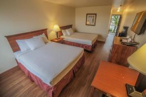 Ένα ή περισσότερα κρεβάτια σε δωμάτιο στο Sunnyside Inn and Suites