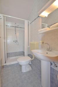 a bathroom with a toilet and a sink and a shower at Apartments Zora in Rakalj