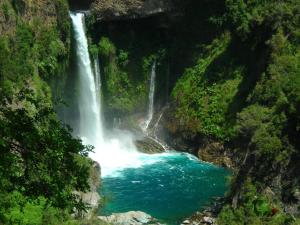 a waterfall in the middle of a river at Hostal Puerta del Sol Molina in Molina