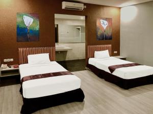 Postel nebo postele na pokoji v ubytování Hotel Sinar 1 + 23 fotografií