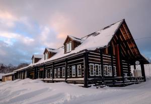 a wooden building with snow on the roof at The Yurts at Margo's Garden, Kiroro in Akaigawa