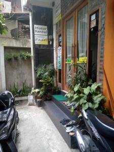 a couple of motorcycles parked outside of a building at Losmen Fadel Malioboro Jogja in Yogyakarta