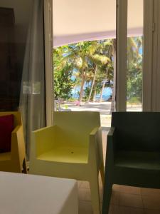a room with a window with a table and chairs at Be On The Beach in Sainte-Anne