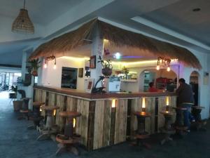 a bar with a bunch of stools around it at Papillon Resort in Chaweng