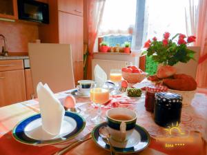a table with cups and plates of food on it at Ferienwohnung Ilona in Zweibrücken +3 photos