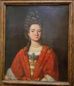 una pintura de una mujer en un vestido rojo en Palazzo Morosini Brandolin Dimora Romantica en Venecia