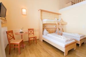 Rúm í herbergi á JUFA Hotel Gitschtal