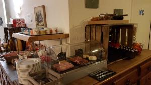 a counter with a buffet with food on it at La Roche du Marais in Omonville-la-Petite