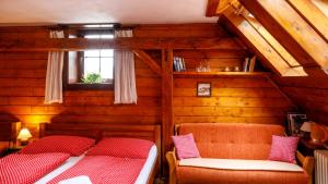 a attic room with two beds and a window at Penzion Barborka in Poprad