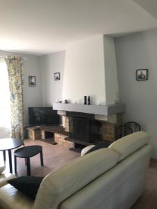 a living room with a couch and a fireplace at Gite du Crinchon in Rivière