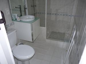 a white bathroom with a toilet and a shower at Les Chênes Verts in Valbonne
