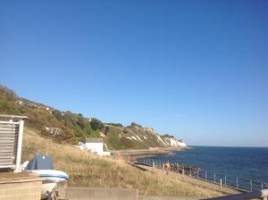 a view of a beach with people walking on it at Angels Corner, Ventnor Bay in Ventnor