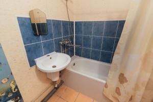 a bathroom with a sink and a toilet and a tub at Apartmens Faraon On Illinskaya 5 floor New Building in Sumy +14 photos