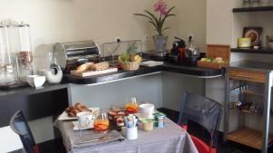 a table with a plate of food on it in a kitchen at Augustin Marie in Bonifacio