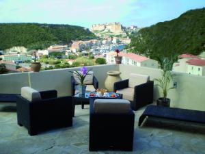 a balcony with couches and a view of a city at Augustin Marie in Bonifacio