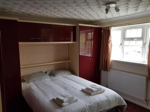 a bedroom with a bed with two towels on it at Spacious Swindon 5 bedroom house - sleeps up to 10 in Swindon