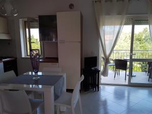eine Küche und ein Esszimmer mit einem Tisch und Stühlen in der Unterkunft Pizzo Apartment 48 in Pizzo