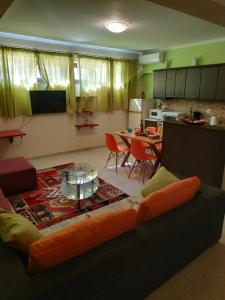 a living room with a couch and a table at Modern Basement Apartment Gio Ii in Zakynthos