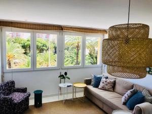 a living room with a couch and two windows at Cabo Palos Apt Salinas Marchamalo*Playa Amoladeras in Cabo de Palos