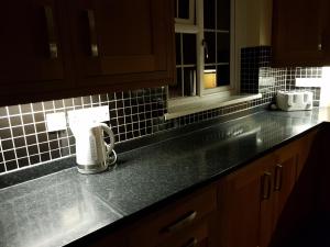 a kitchen counter with a toaster on a counter top at Spacious Swindon 5 bedroom house - sleeps up to 10 in Swindon