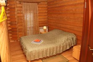 a bedroom with a bed in a log cabin at Green Style in Kyiv