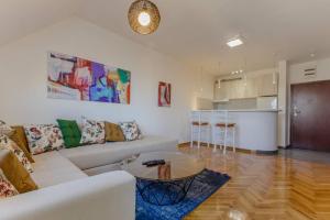 a living room with a white couch and a table at Old town Beauty Apartment with great view in Podgorica