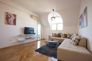 a living room with a couch and a table at Old town Beauty Apartment with great view in Podgorica