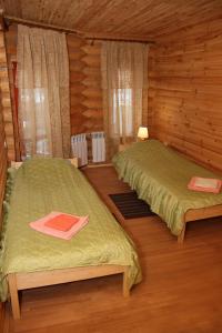 a bedroom with two beds in a log cabin at Green Style in Kyiv