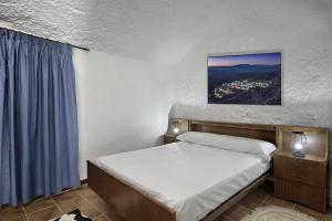 Posteľ alebo postele v izbe v ubytovaní Cueva Alcázar