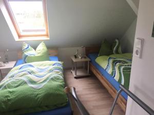 a room with two beds and a window at Ferienwohnungsvermietung Leitel in Brandenburg an der Havel