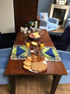 een houten tafel met brood en ander voedsel erop bij Burgers & Buitenlui in Diever