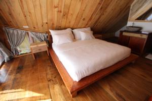 Voodi või voodid majutusasutuse Padi Ecolodge toas