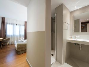 a bathroom with a sink and a mirror at Hotel Airiños 3* in Cangas de Morrazo +37 photos