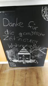 a chalkboard with a sign with a house on it at Wohnung im Schwedenhaus in Bad Laasphe
