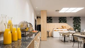 a kitchen with orange juice bottles on a counter at Hotel Airiños 3* in Cangas de Morrazo