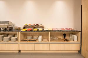a kitchen with a counter with plates and dishes at Hotel Airiños 3* in Cangas de Morrazo