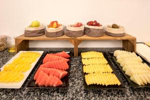a buffet with several different types of food on trays at Hotel Airiños 3* in Cangas de Morrazo