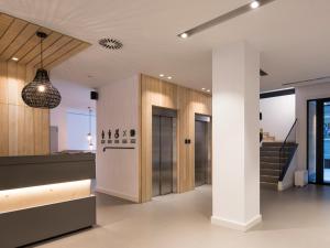 a lobby of a building with a staircase at Hotel Airiños 3* in Cangas de Morrazo