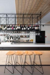 a kitchen with two stools in front of a counter at Hotel Airiños 3* in Cangas de Morrazo